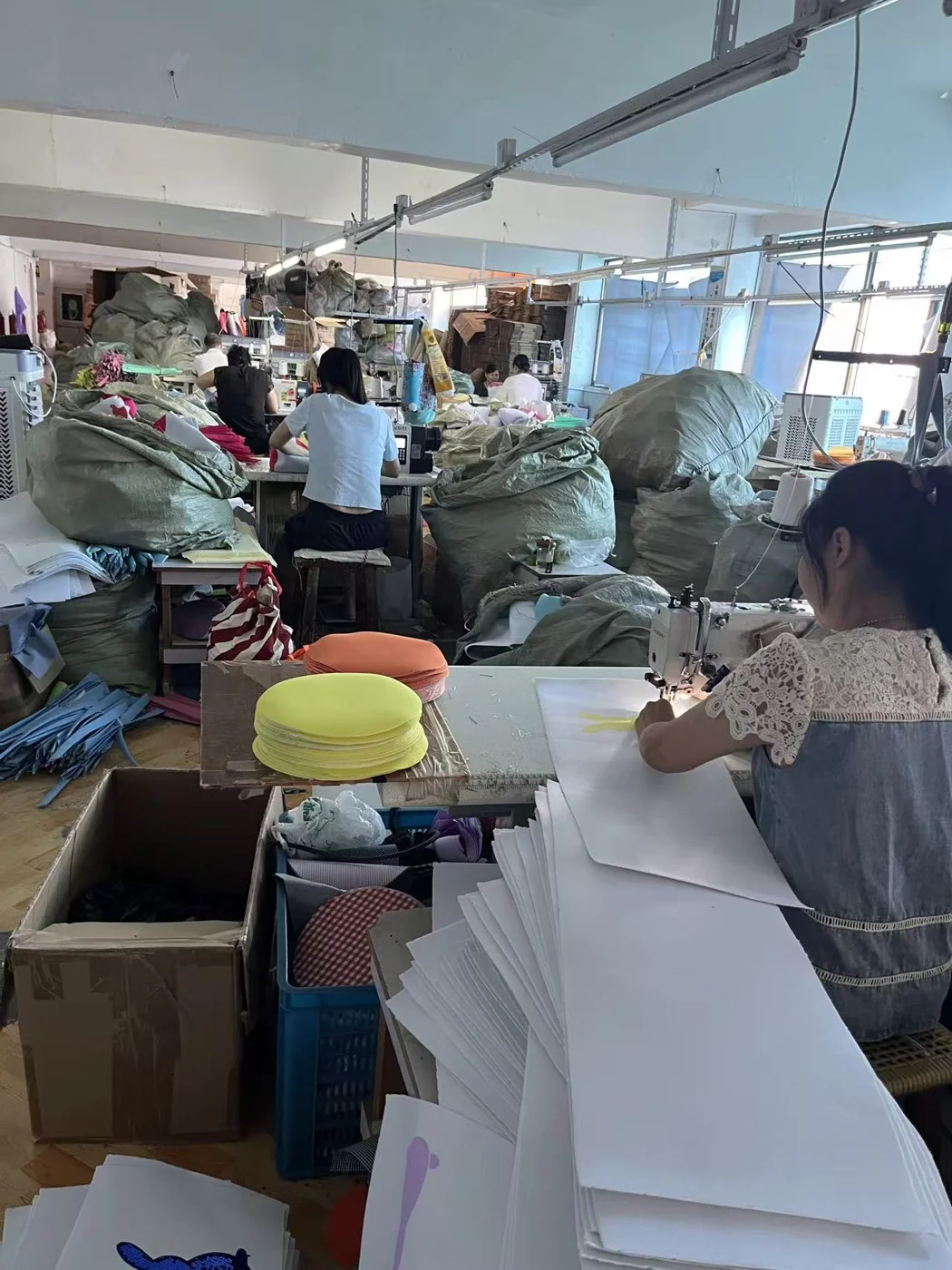 Holdfly Crafts workshop with staff sewing fabric holiday products
